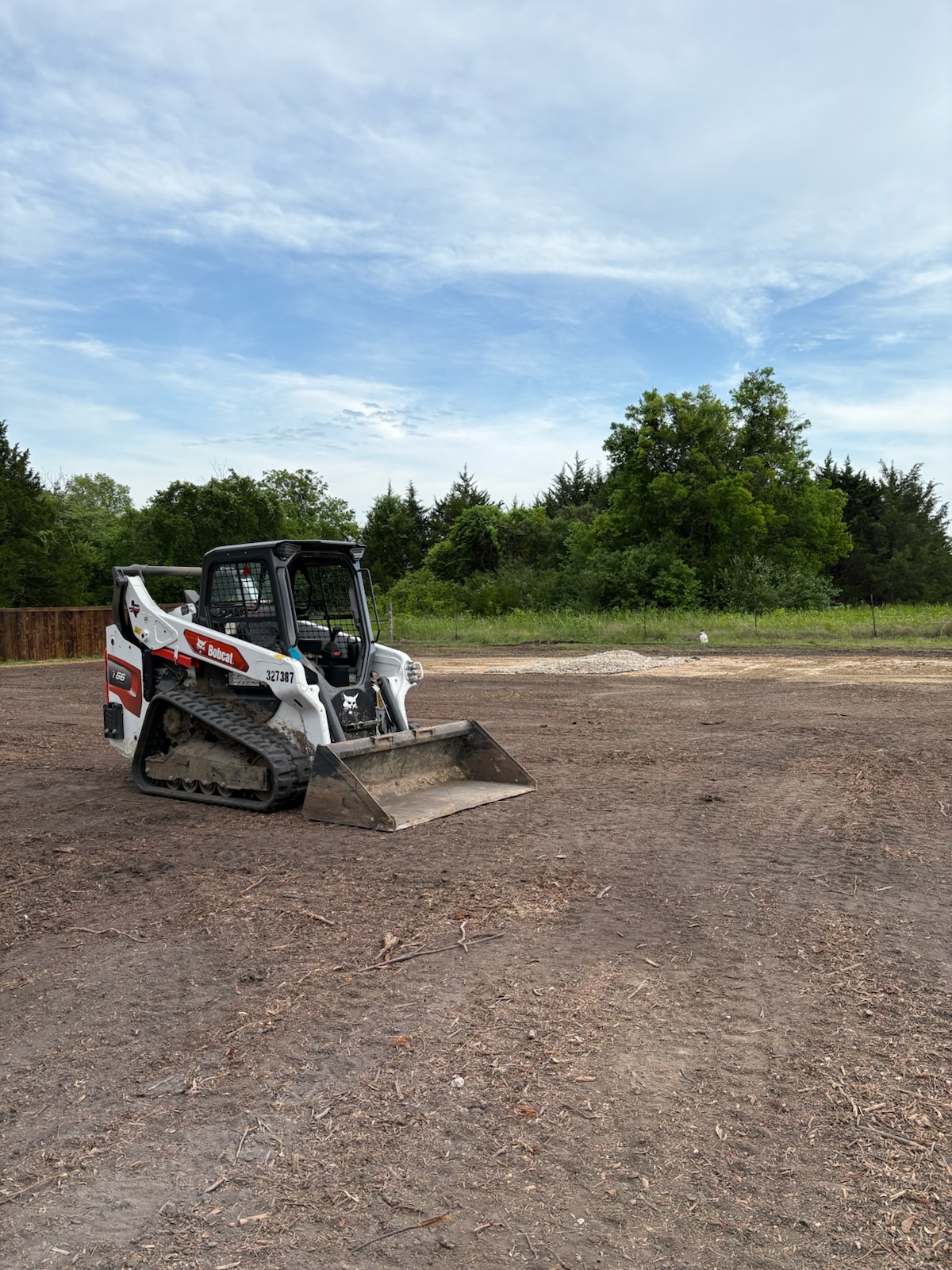 Skid steer on a graded lot ready for construction